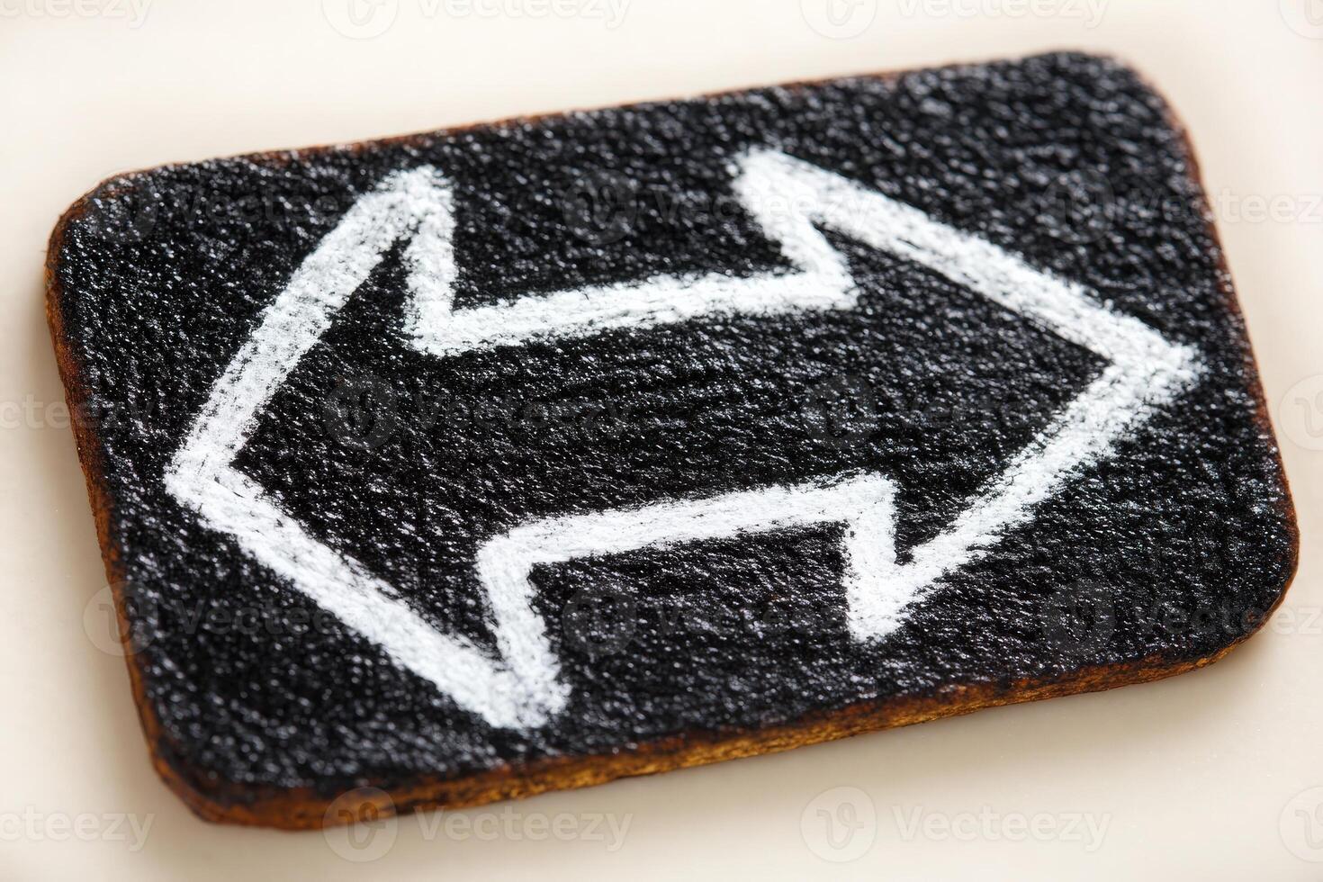 A rectangular sign features a black textured background with bold white arrows pointing left and right. This vibrant design serves as a directional guide, clearly indicating choices. photo