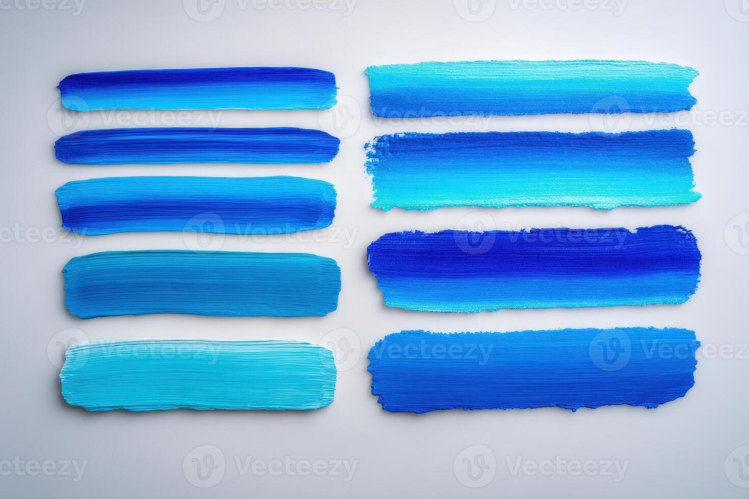 Bold strokes of various blue hues are neatly arranged, showcasing a gradient from light to dark shades. The smooth texture highlights the richness of the colors, inviting creative inspiration. photo