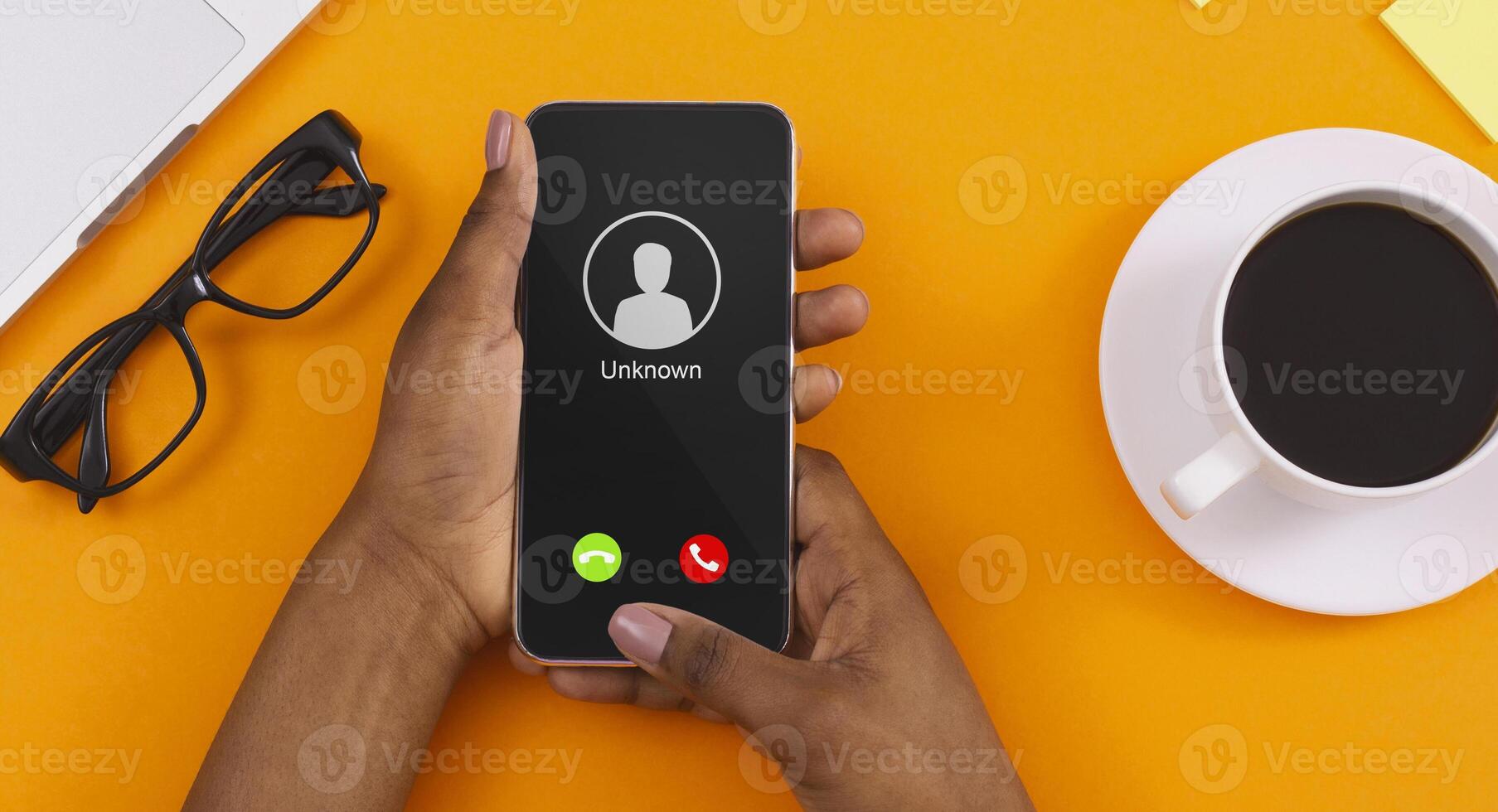 Close up Top View Of Black Female Hand Holding Phone With Incoming Call From Unknown Caller photo