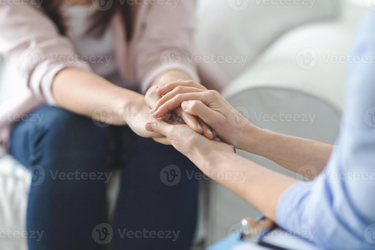 Loneliness, despair, depression concept. Close up of psychologist touching female patient hands, specialist comforting sad woman photo
