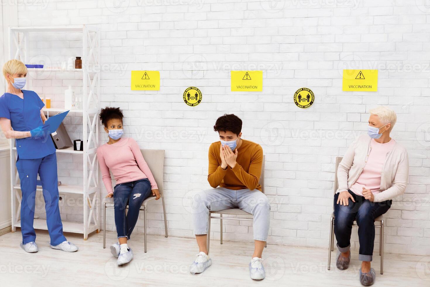 Asian Man With Pneumonia Coughing Scaring Patients Sitting In Queue Waiting For Doctor's Appointment In Hospital. Coronavirus, Covid-19 Pandemic, Vaccination And Covid Treatment Concept photo