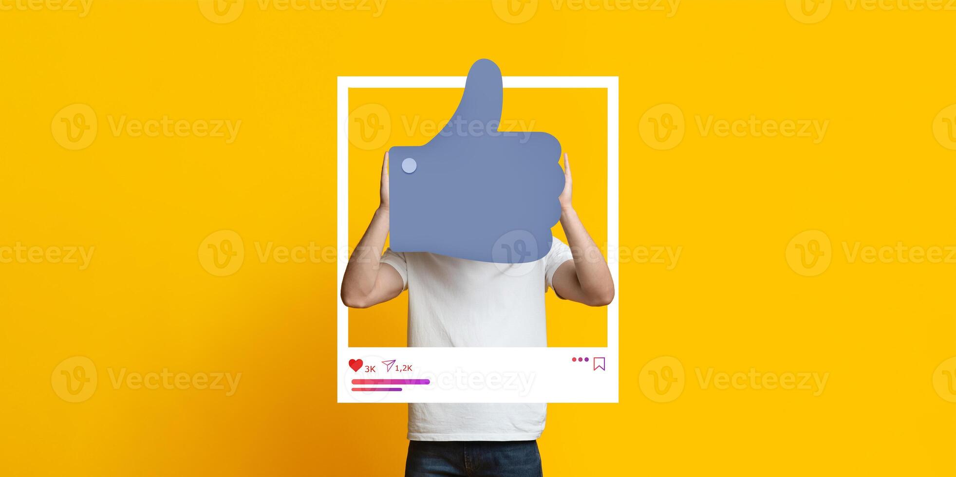 A person showcases a thumbs up gesture while posing in front of a vibrant yellow background, highlighting their support for social media engagement as a blogger or influencer. photo