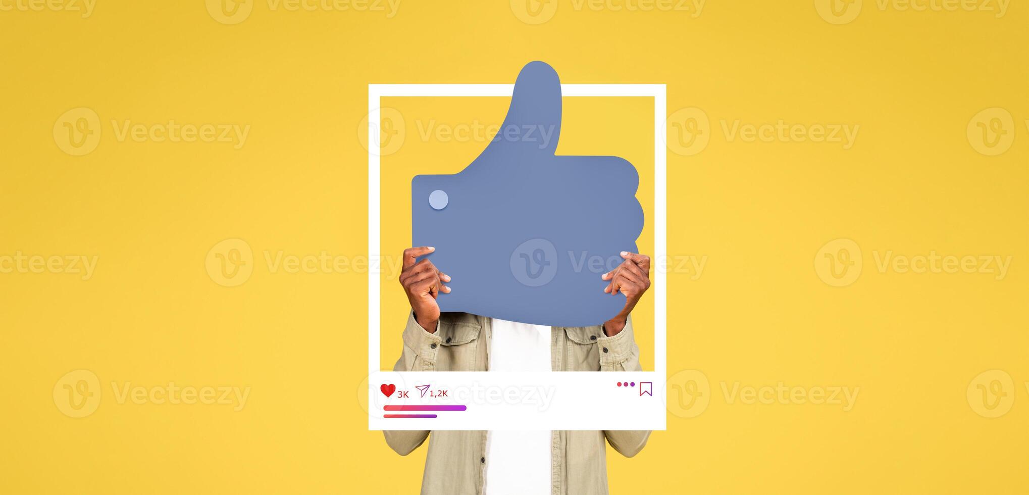 In a bright yellow setting, an individual holds a large thumbs up symbol associated with social media engagement. This represents the influence of online content creation and interaction. photo