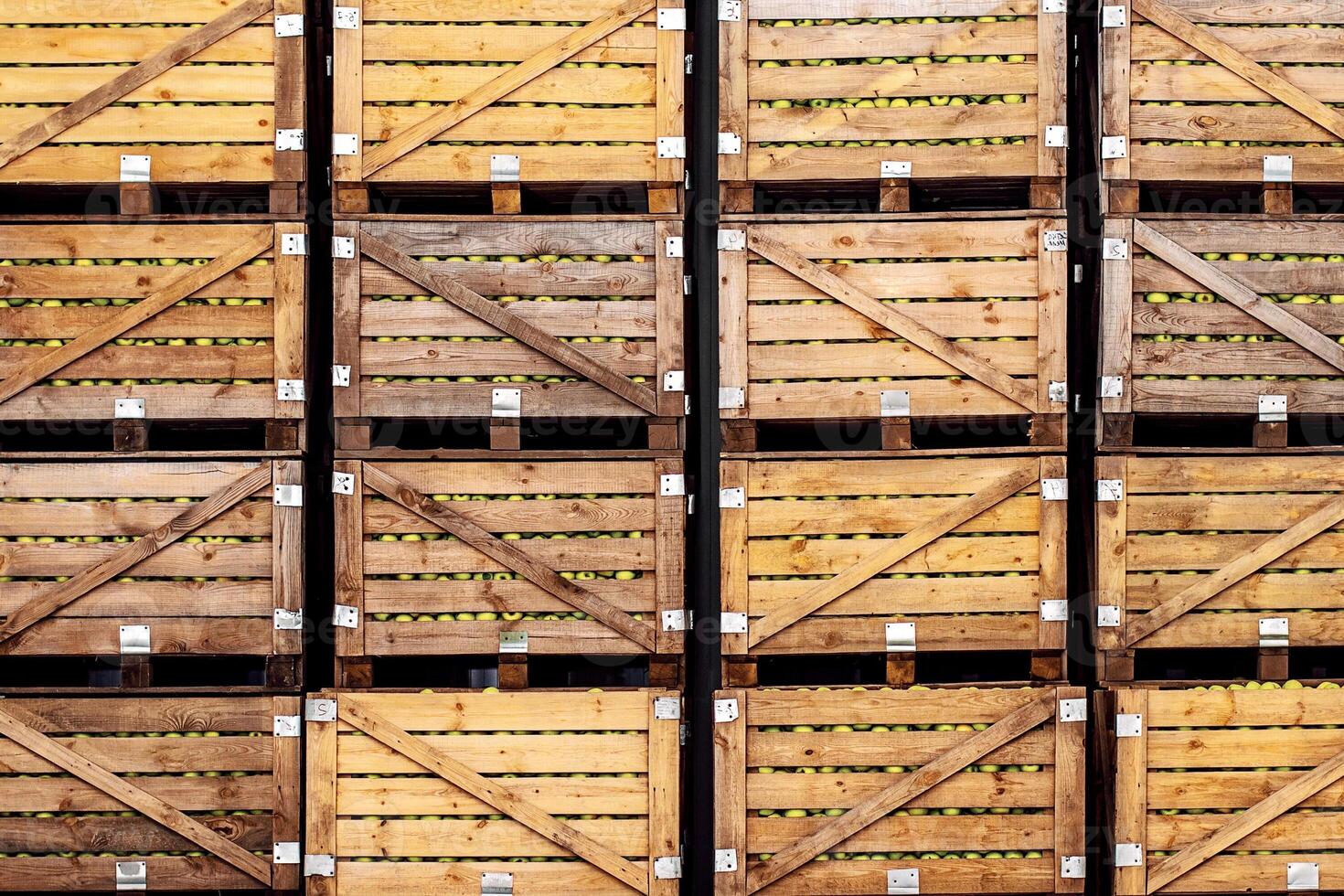 Large harvest of organic fruits for sale in stock. Business, industry and juice production on plant. Many apples in wooden boxes in farm, warehouse or store, white background, indoor, copy space photo