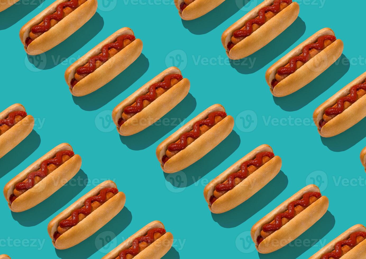 Set Of Tasty Hot Dogs With Sausage And Ketchup Flat Lying On Turquoise Background, Creative Repeat Pattern, Geometrical Design, Top View photo