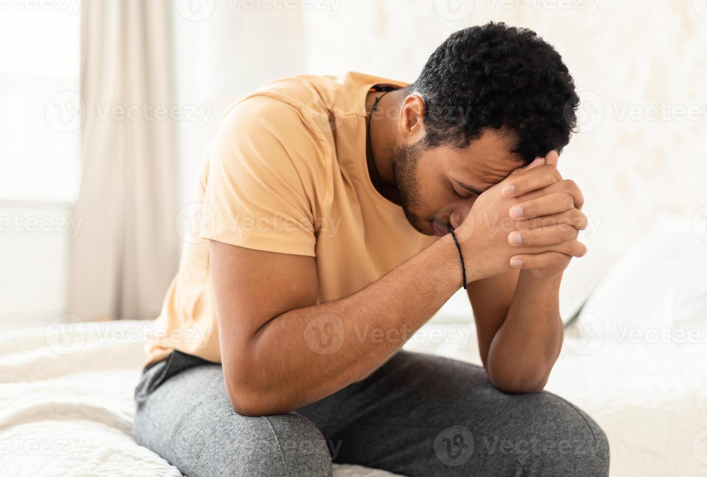 Male Depression. Unhappy Middle Eastern Guy Covering Face Having Stress And Problems Sitting In Bedroom At Home. Unrecognizable Man Suffering From Depressing Thoughts. Mental Health Concept photo