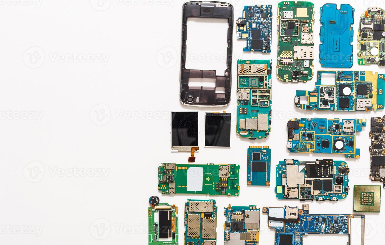 Mobile repair flat lay background. Dissasembled smartphone top view, copy space. Technician workplace with instruments and cell phone components photo
