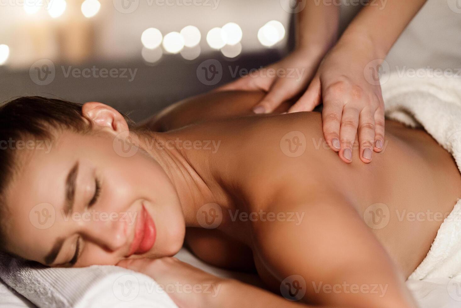 Millennial Woman Enjoying Back Massage In Spa Salon, Relaxing With Closed Eyes photo