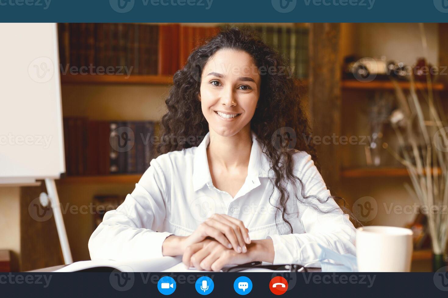 Virtual Communication. Head shot portrait of smiling young female employee worker sitting at desk, having call with colleagues at online meeting, using computer software app, laptop screen view photo