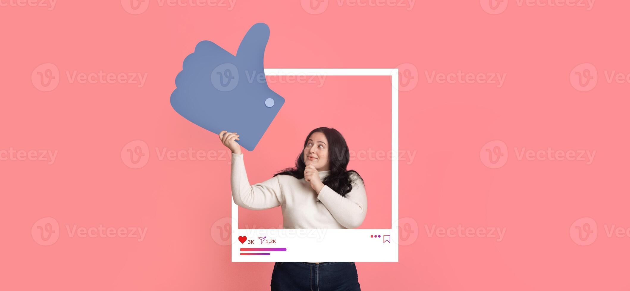 A person stands against a bright pink background, holding a large thumbs up sign, expressing excitement about social media engagement. They appear enthusiastic and ready to create content. photo