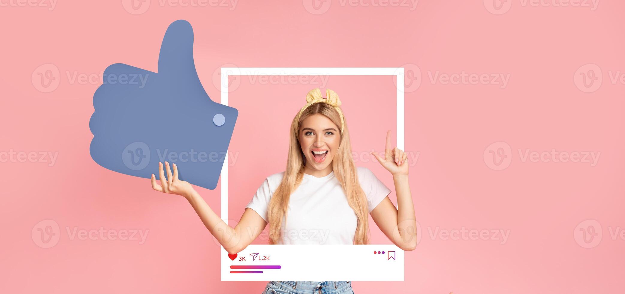 A young influencer joyfully poses against a pink background, holding a large thumbs up symbol. She showcases excitement while interacting with her online audience, promoting positivity and engagement. photo