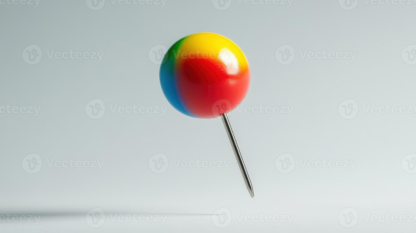 Colorful pushpin floating against a neutral background. photo