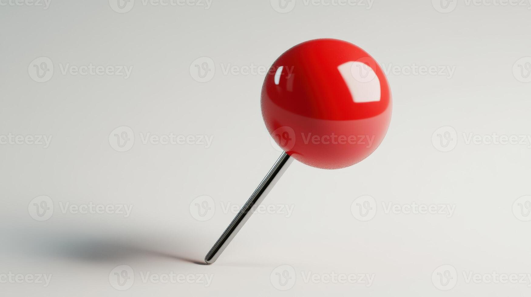 Glossy, red pushpin on a light background. photo