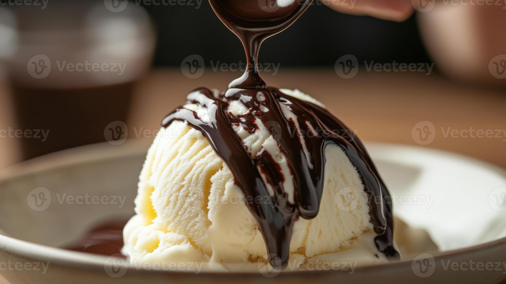 Close-up view of vanilla ice cream topped with dark chocolate sauce. photo