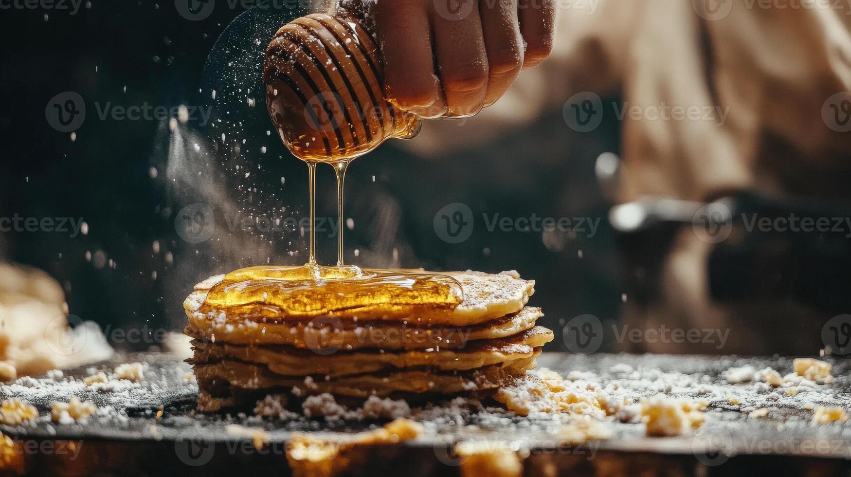 Honey dripping onto a stack of golden pancakes. photo