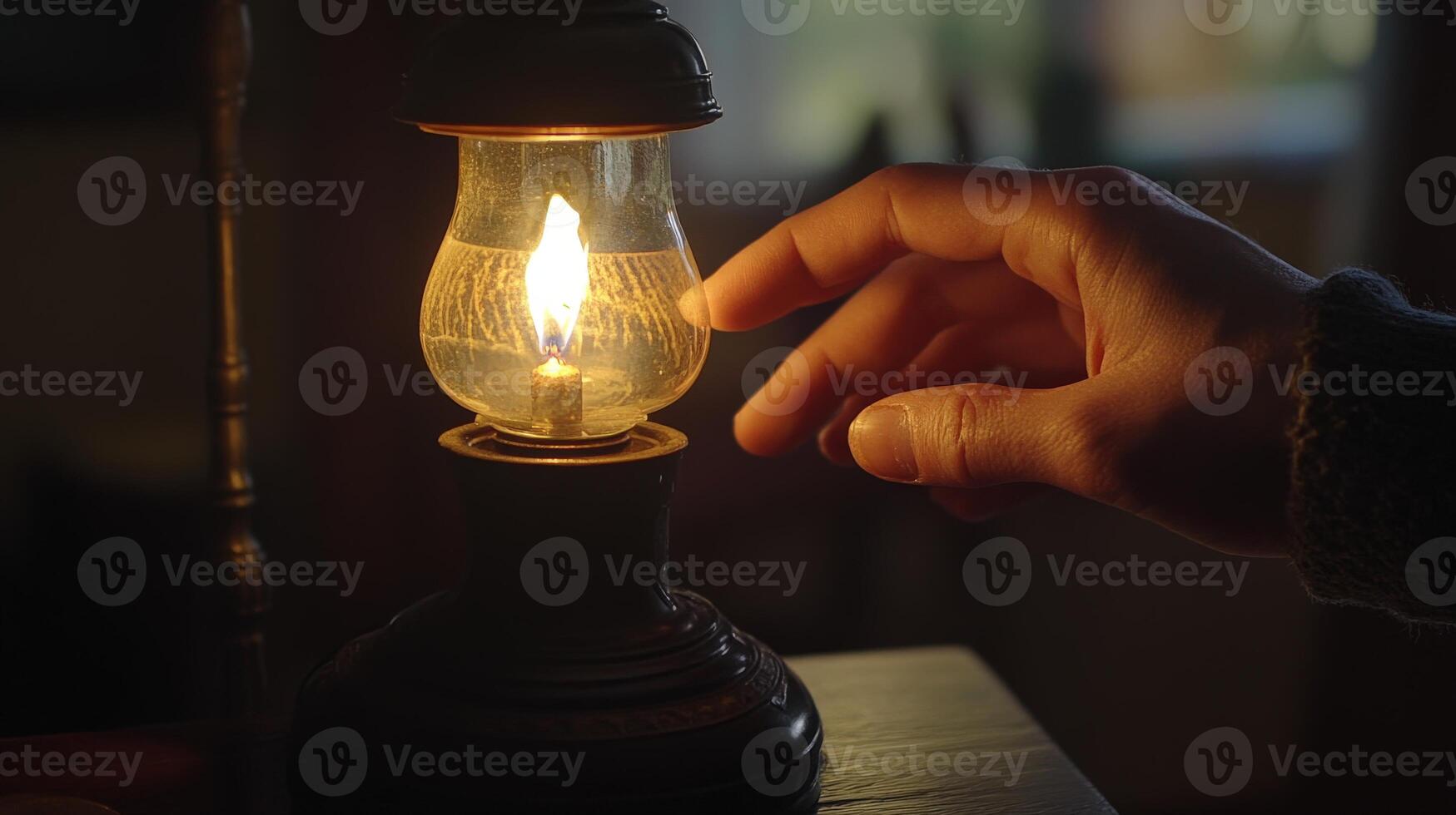 Close-up of a hand adjusting a vintage kerosene lamp. photo