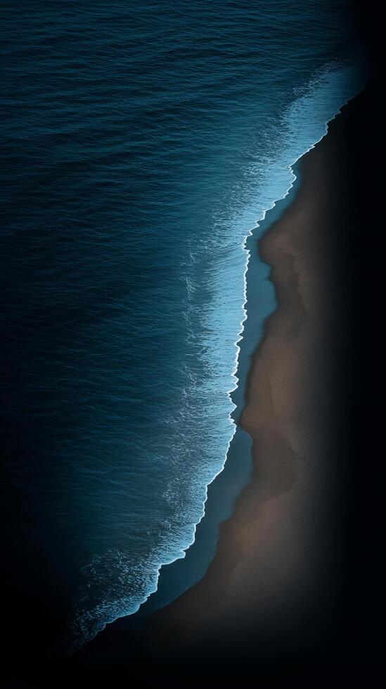 Dark Night Beach Scene Dramatic Aerial View of Ocean Waves Crashing on Shore. Stunning Coastal Landscape Photography. Perfect for Wallpaper or Art Print. photo