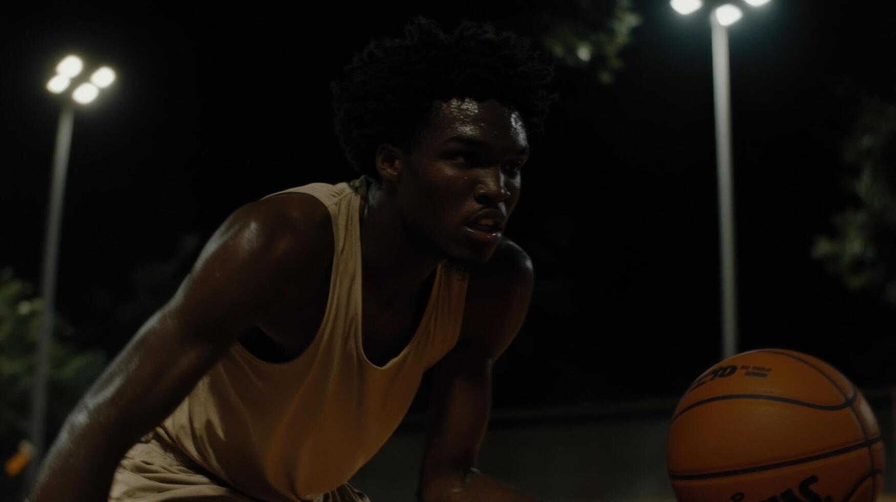 Night Basketball Game Intense Streetball Action Under the Lights. A Focused Athlete Shows Determination and Passion for the Game. photo