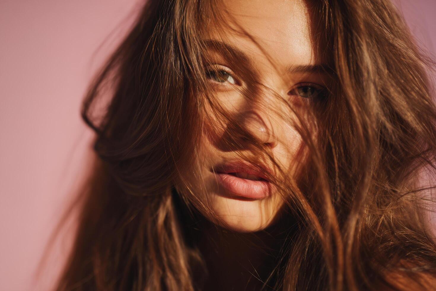 portrait of a sensual woman with long flowing hair, showcasing her beauty and elegance. The image is bathed in soft sunlight again photo
