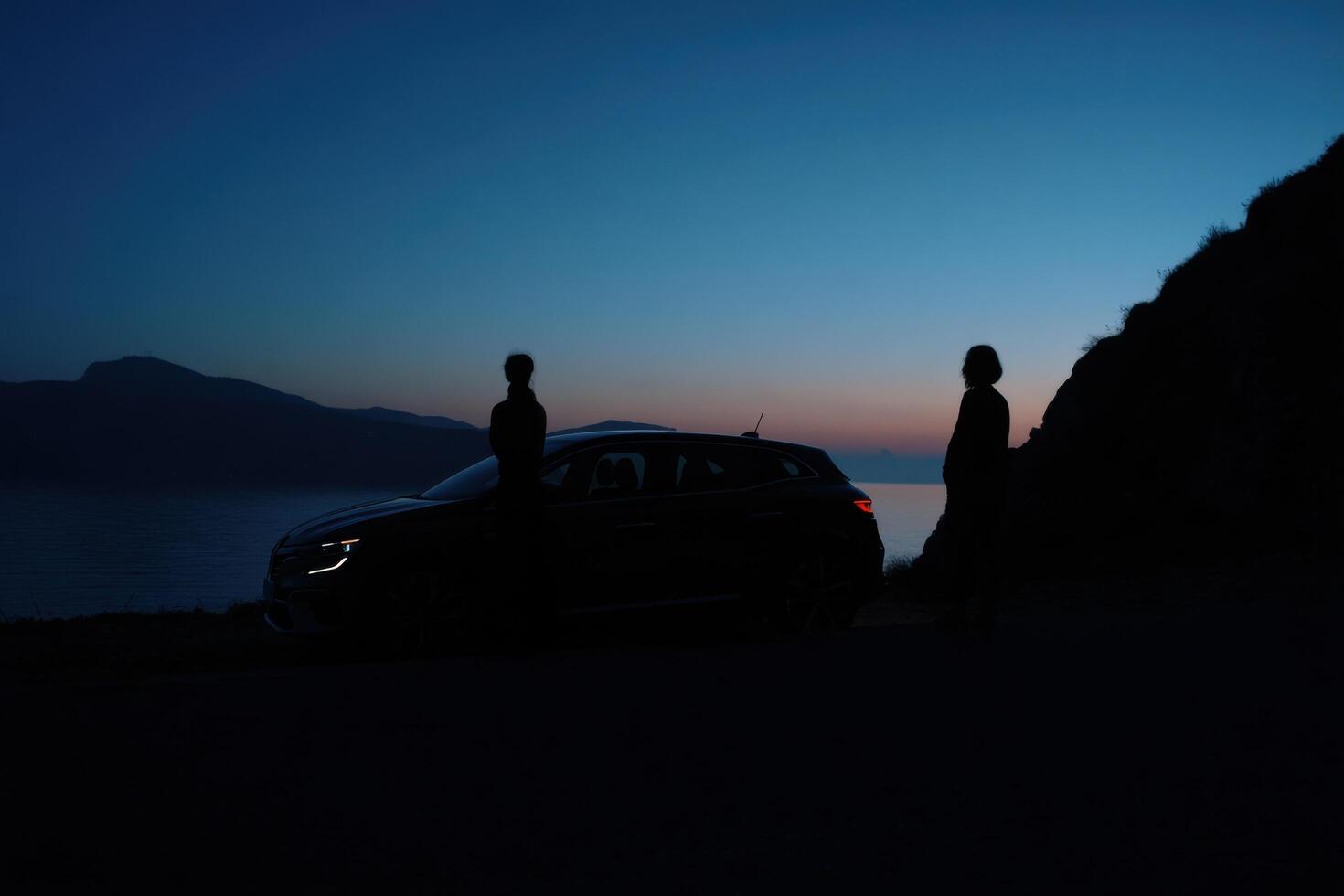 Serene Evening Road Trip A Couples Scenic Drive at Sunset, Enjoying the Breathtaking Ocean and Mountain Views. A Journey of Explor photo