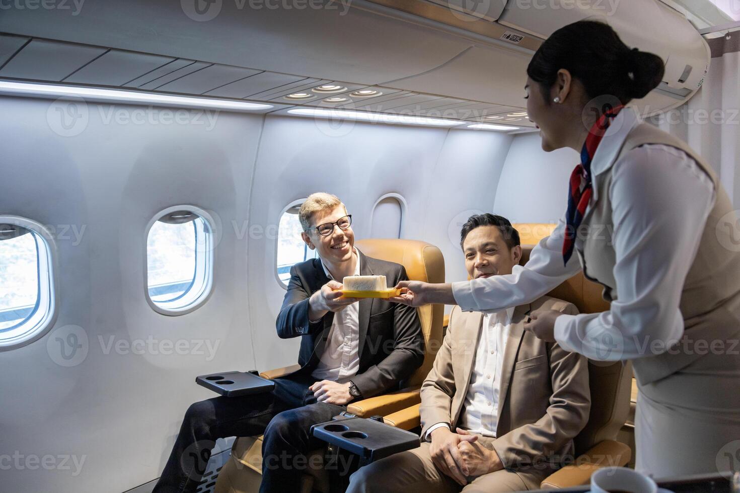 Flight attendant is serving food to the customer for in flight meal, airline travel and transportation photo