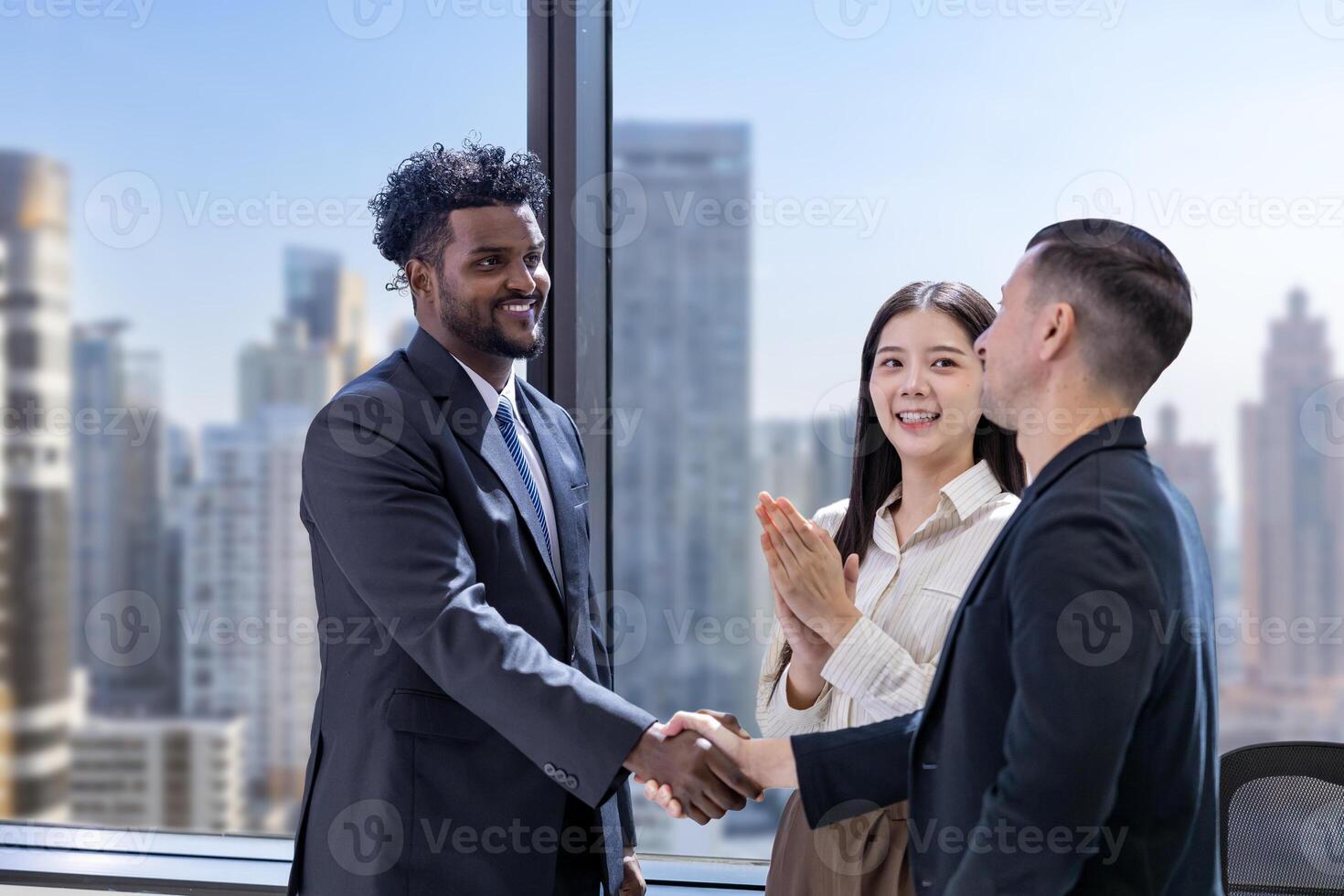 Team of diversity business people having agreement and handshake over new strategic strategy project deal on investment real estate with recognition and applause from other colleague for partnership photo
