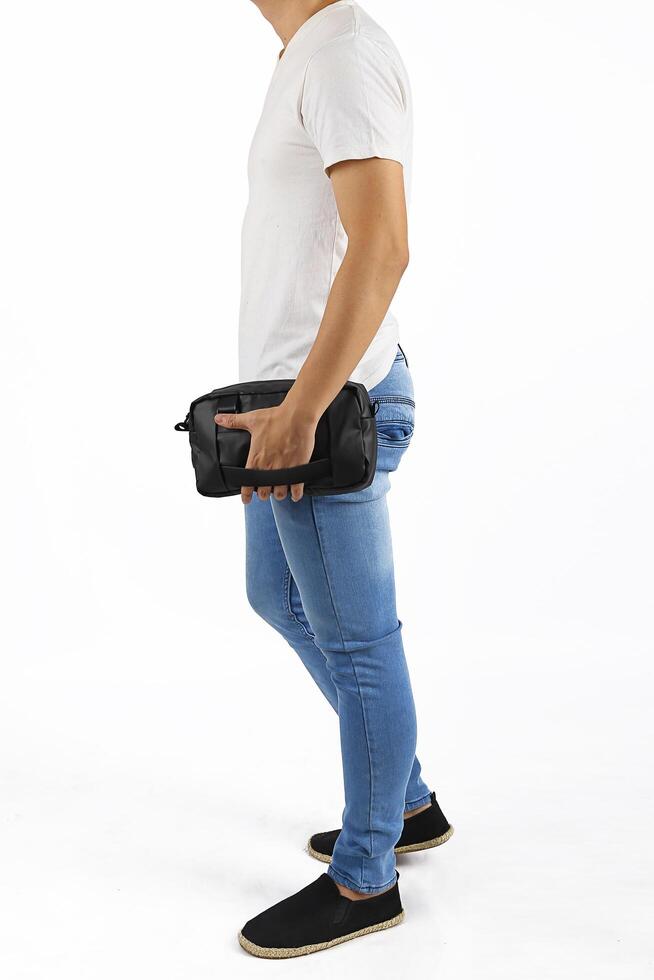 Young man holding clutch bag photo