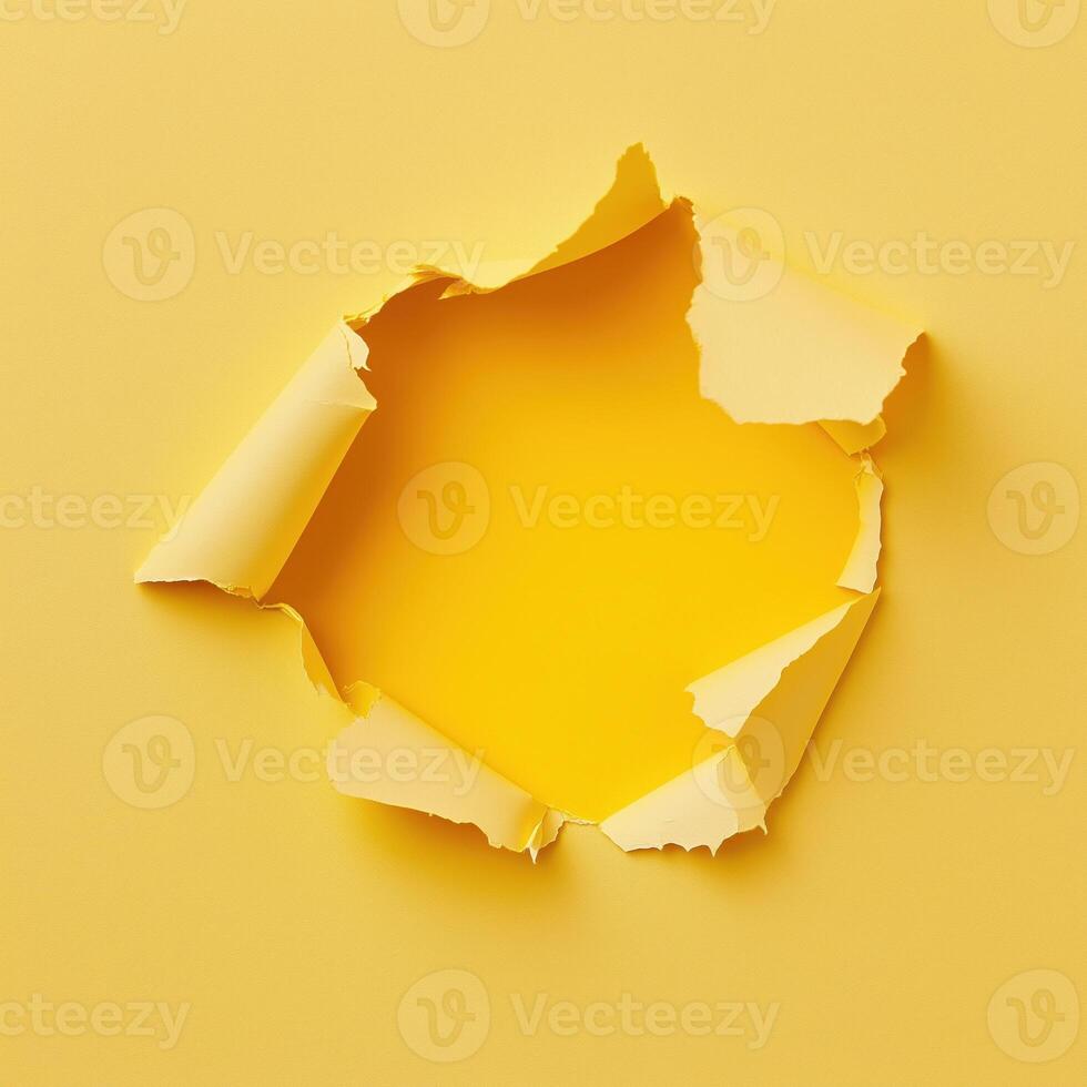 Close-up of torn yellow paper with a jagged hole in the center photo