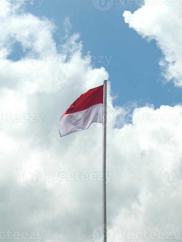 Indonesian Flag under Blue Sky photo