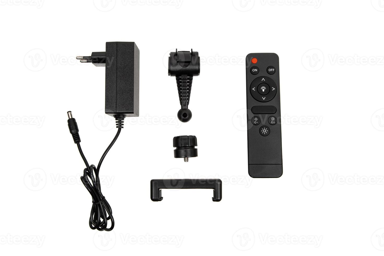 Set of lamp accessories including power adapter, remote, and mounting parts on white back photo