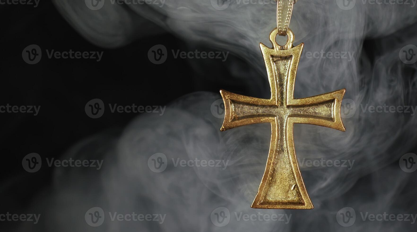 Christian Religion Symbol Metallic Cross in Smoke Ambiance photo