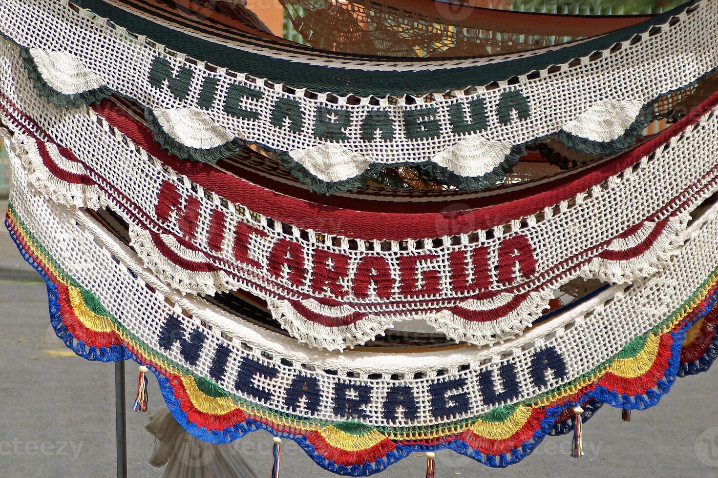 A clock with a bunch of different colored knitted banners photo