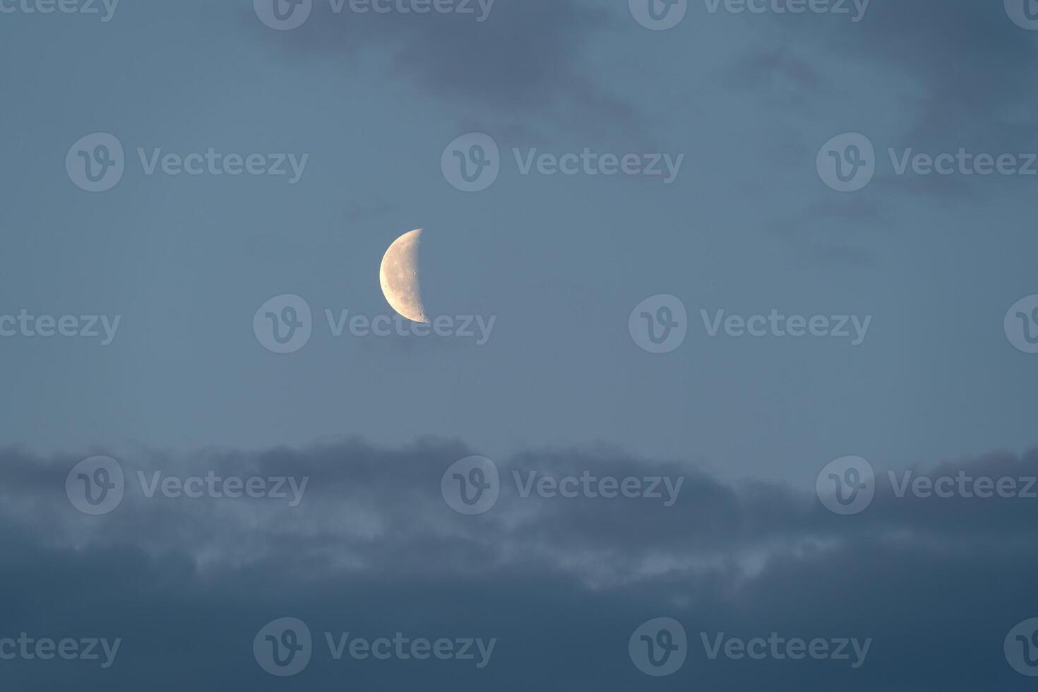 The moon is seen in the sky with clouds photo