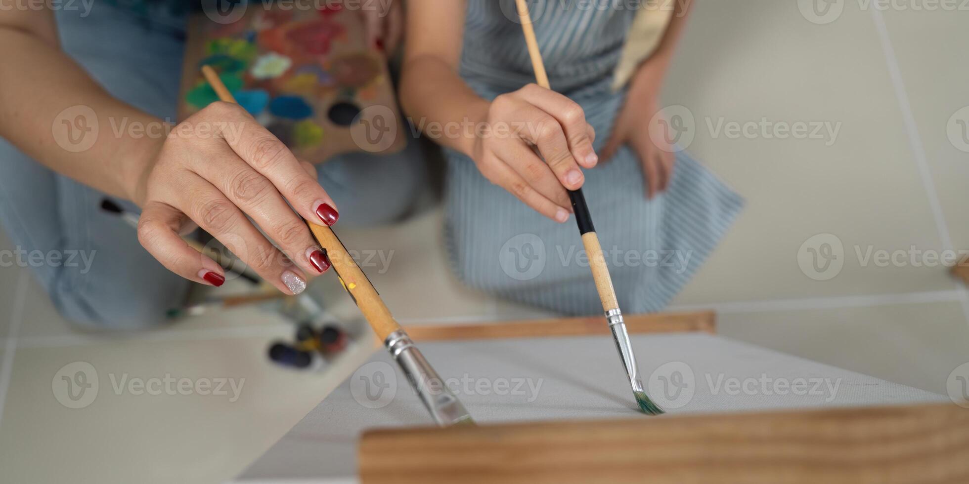 Activity mother and daughter painting close up of hands creating art photo