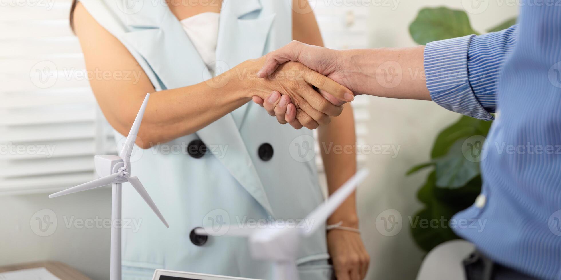 Sustainability partnership. Handshake between two colleagues in an office photo