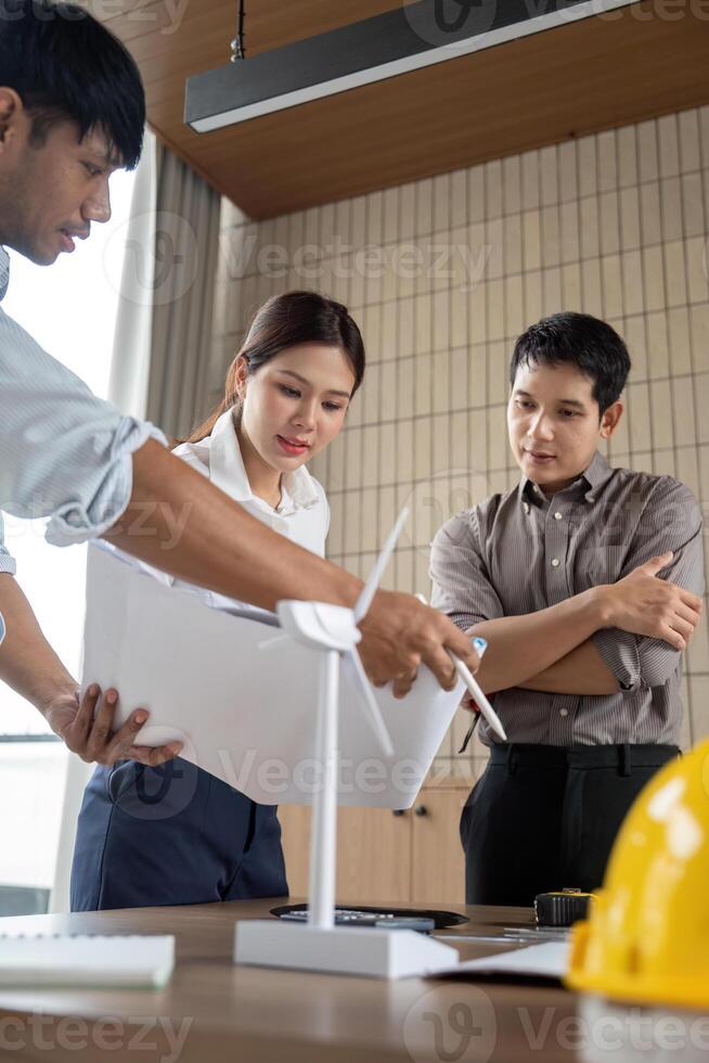 Sustainability engineers reviewing environmental impact reports in the office photo