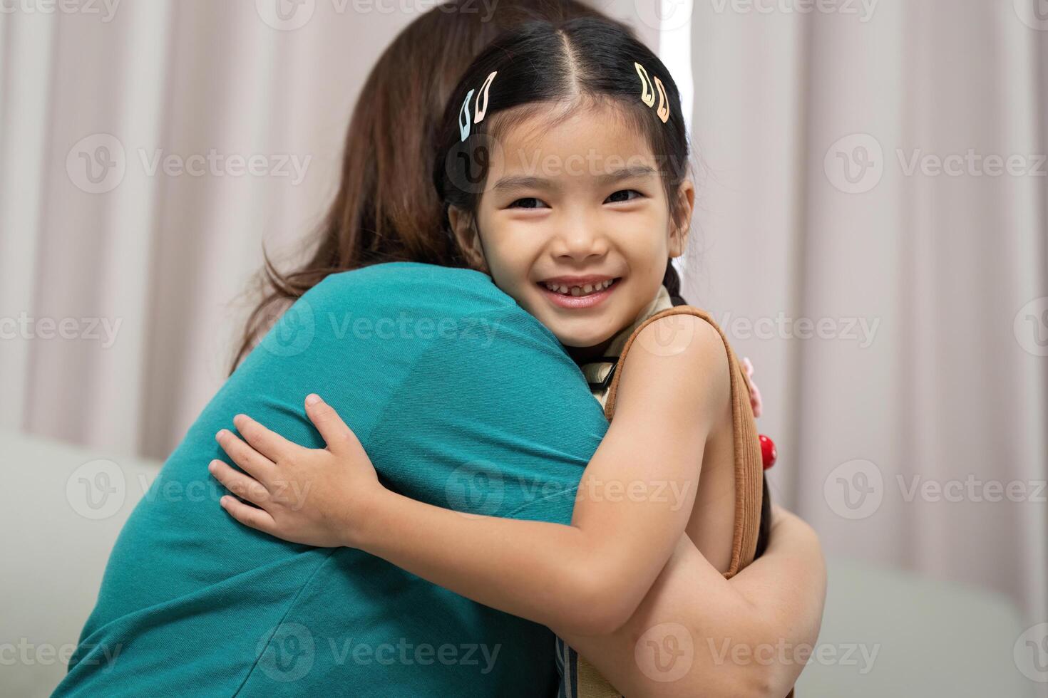 Activity of a mother hugging her daughter with joy and love photo