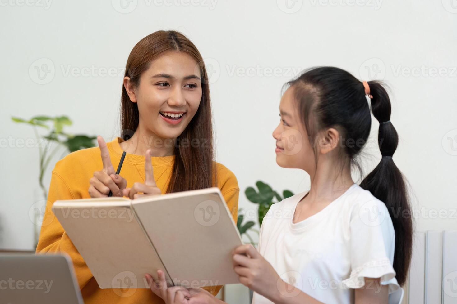 Back to School. Joyful mother and daughter studying together photo