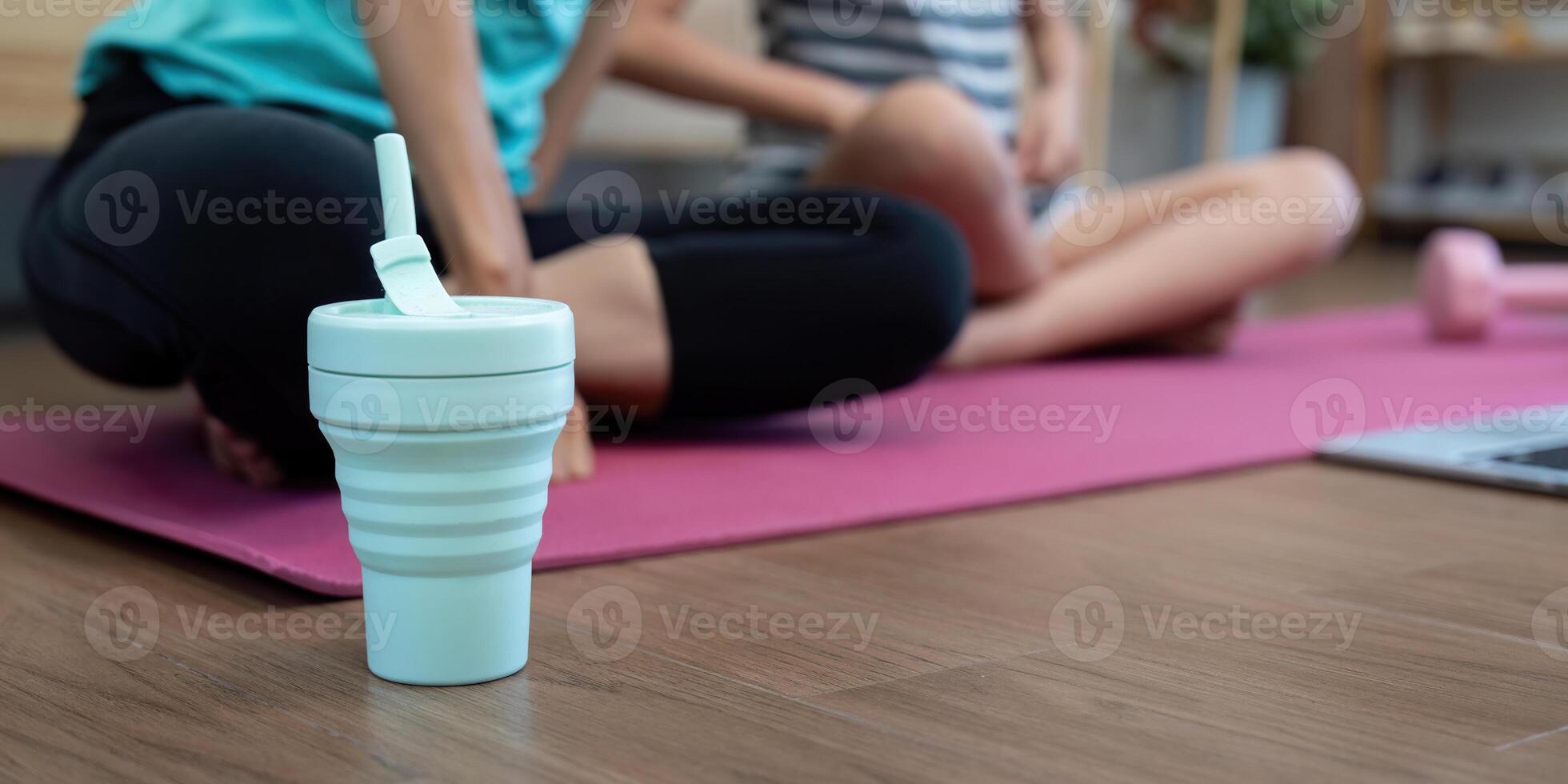 Wellness Hydration. Focus on a water bottle during yoga session photo