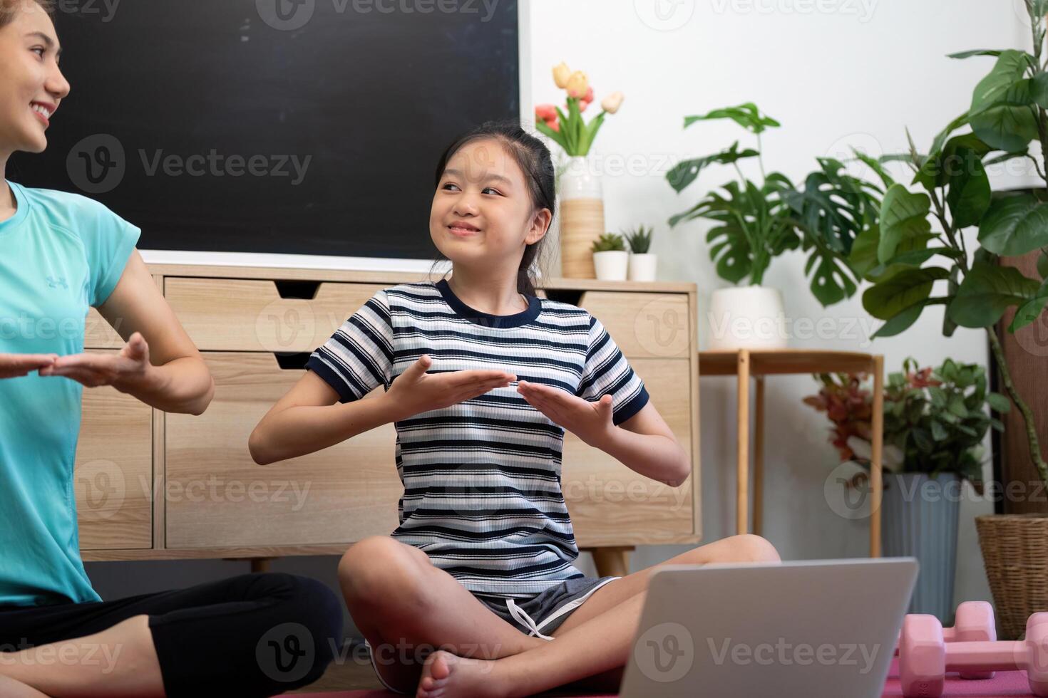 Wellness yoga interaction between mother and daughter with laughter photo