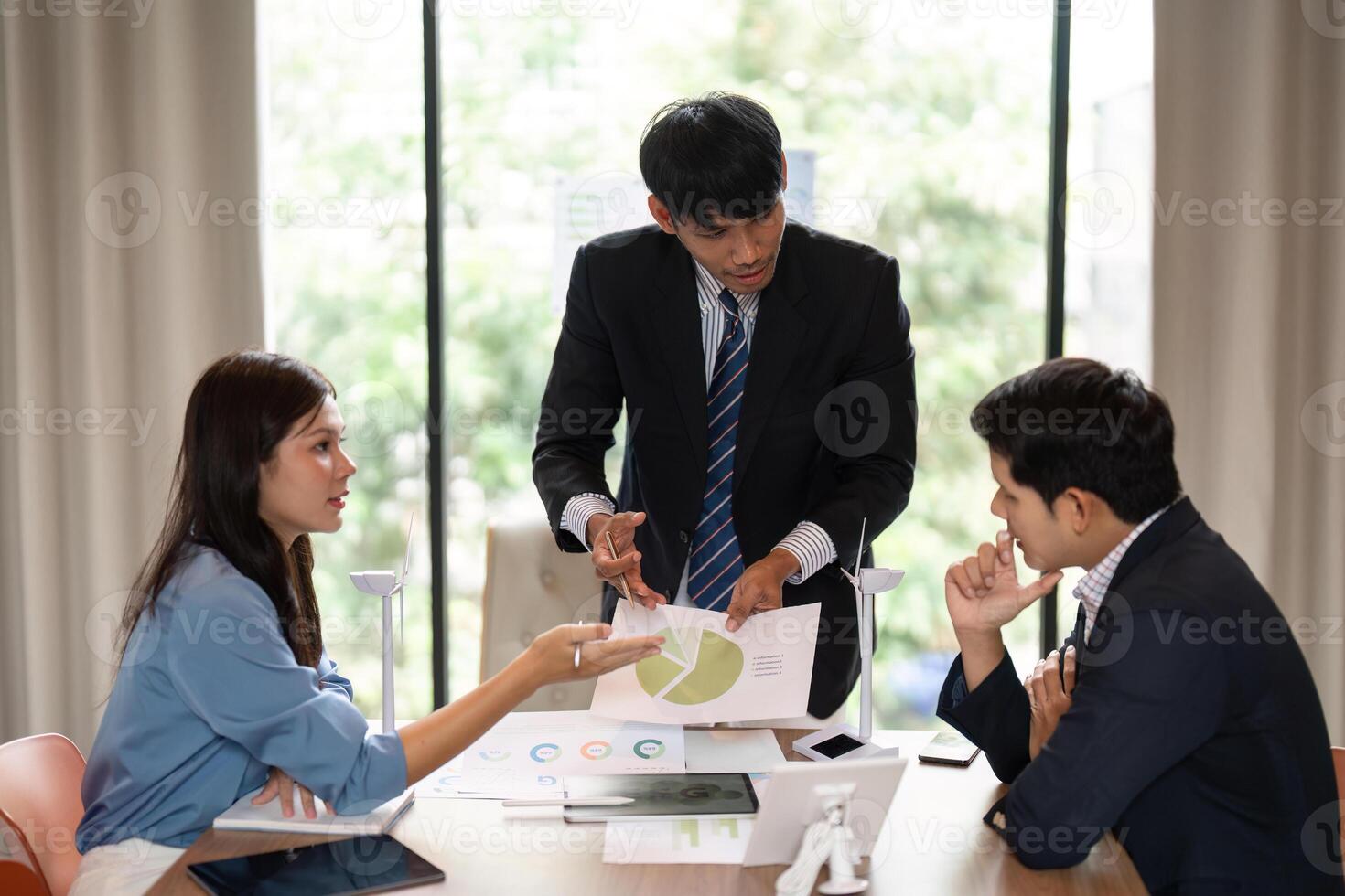 Sustainability and ESG Discussion. Professionals collaborating on environmental strategies in a modern office. photo