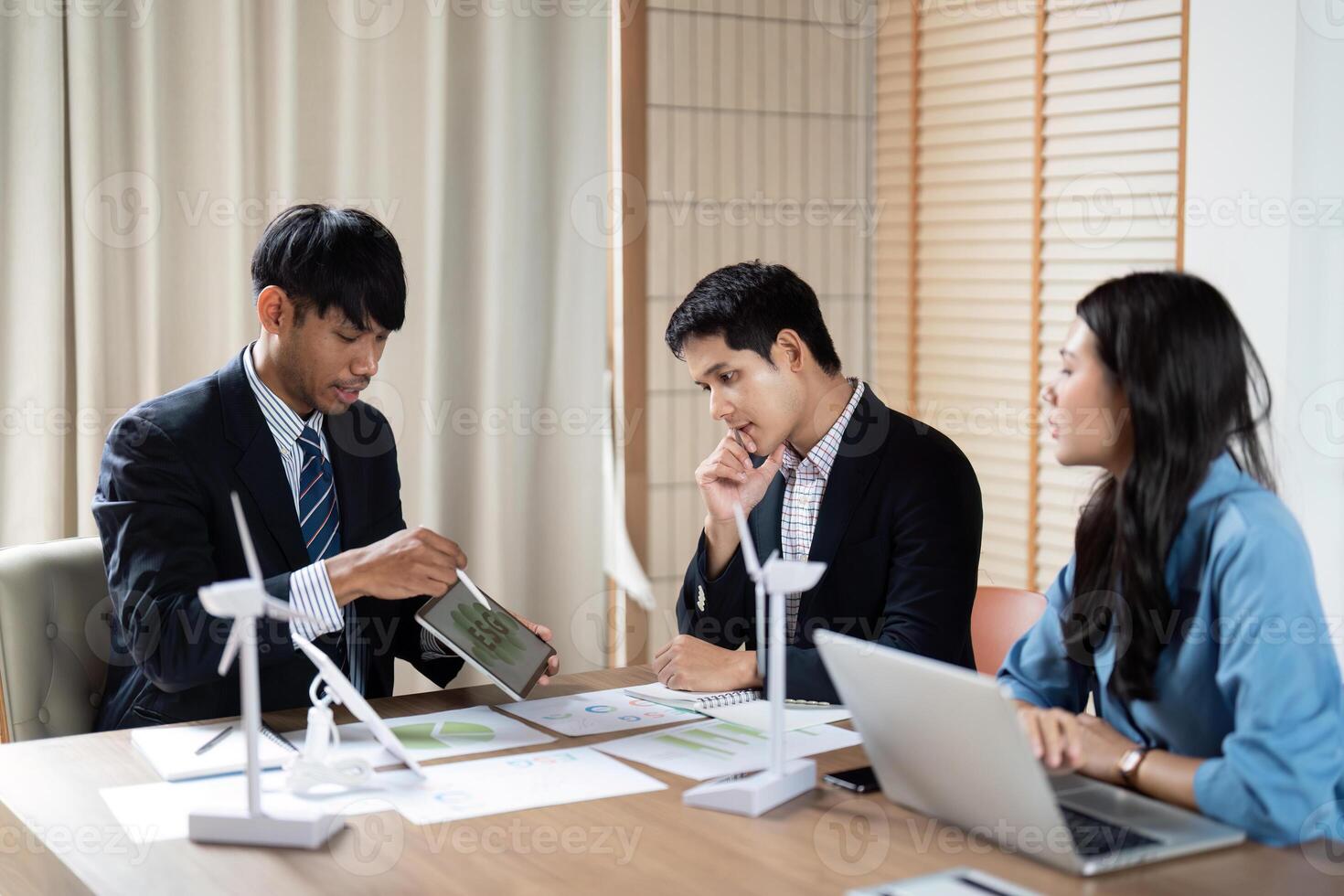Sustainability and ESG Focus. Professionals reviewing environmental data and strategies in a collaborative meeting. photo