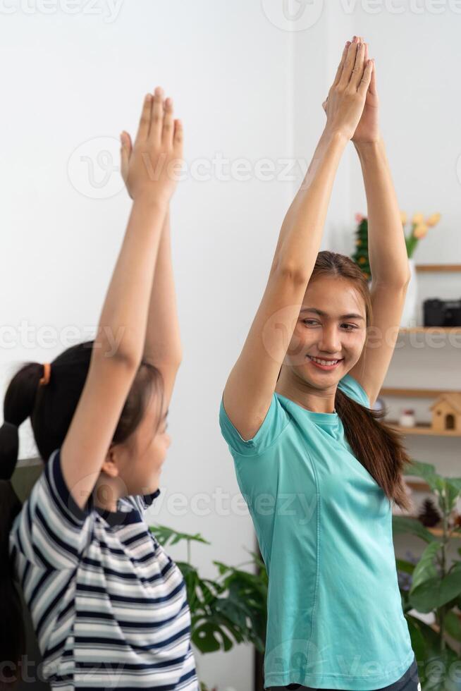 Mother and daughter stretching together for wellness photo