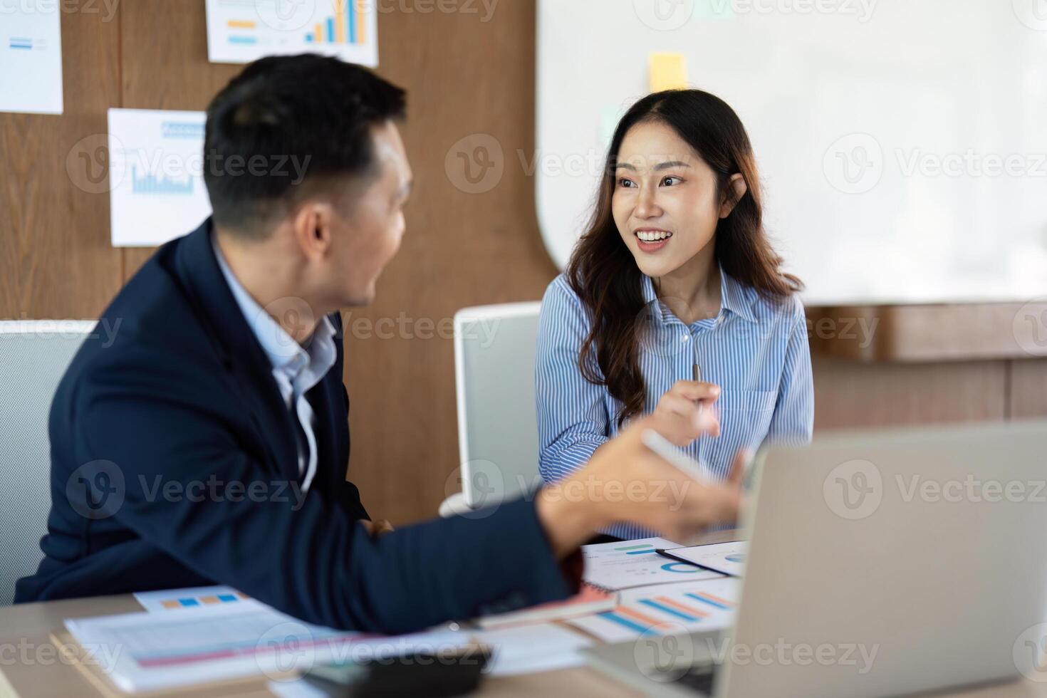 Team Collaboration. Two professionals discussing strategies in a modern office. photo