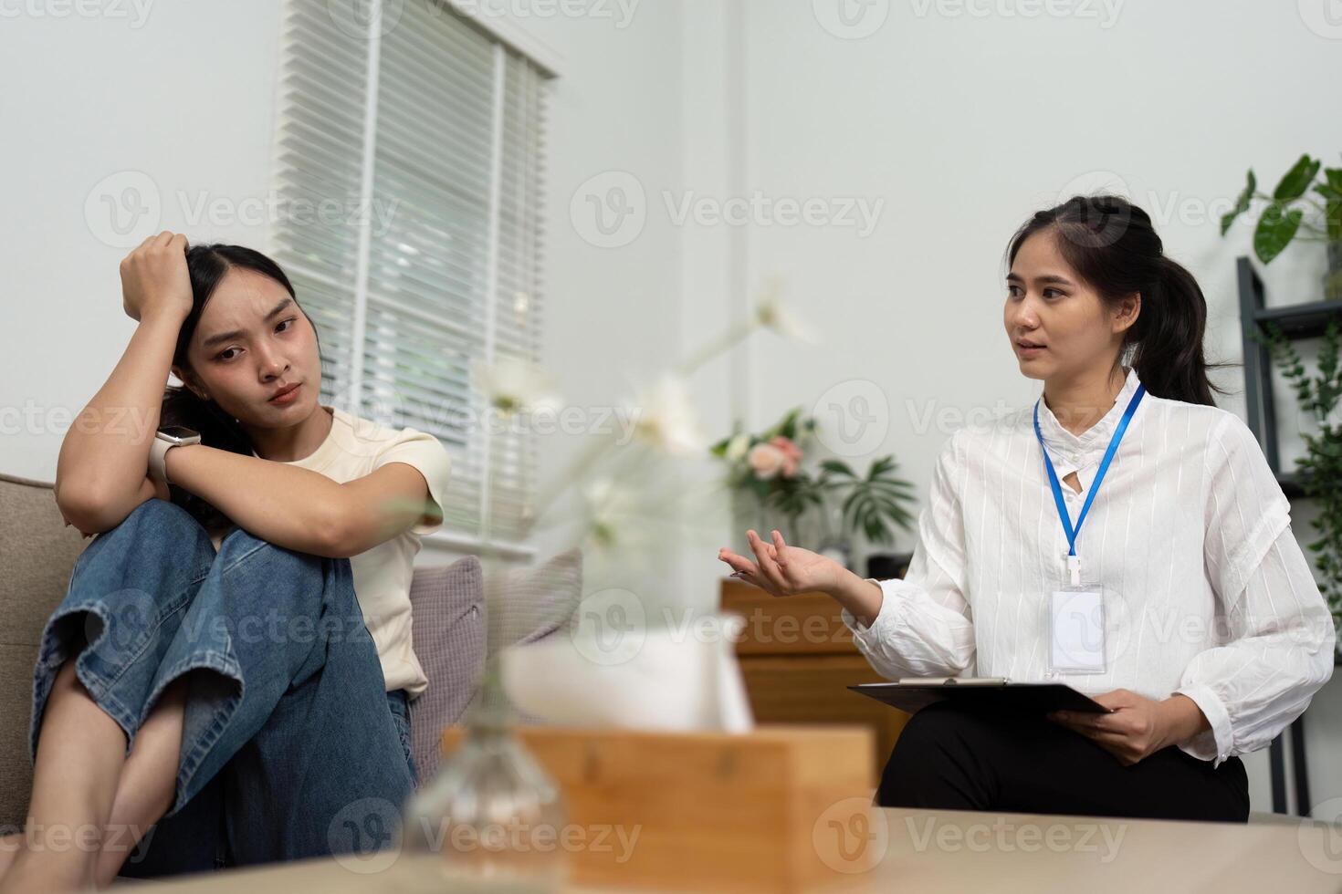 Psychologist discussing emotional issues with a patient in therapy photo