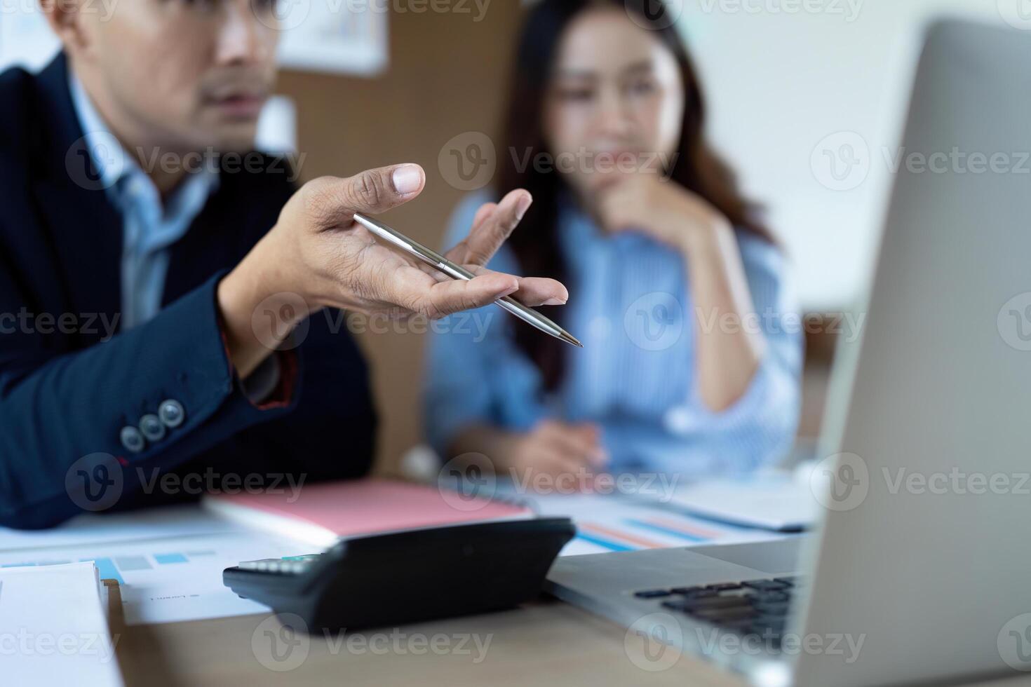 Focused Business Discussion. Professionals analyzing data and discussing strategies in a modern office. photo