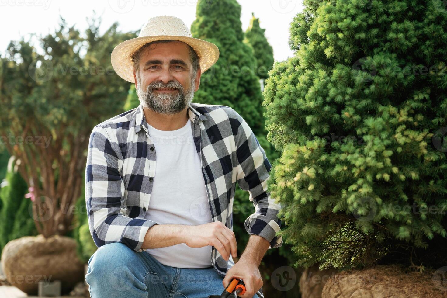 Beautiful ,portrait... Senior gardener is at work at daytime photo