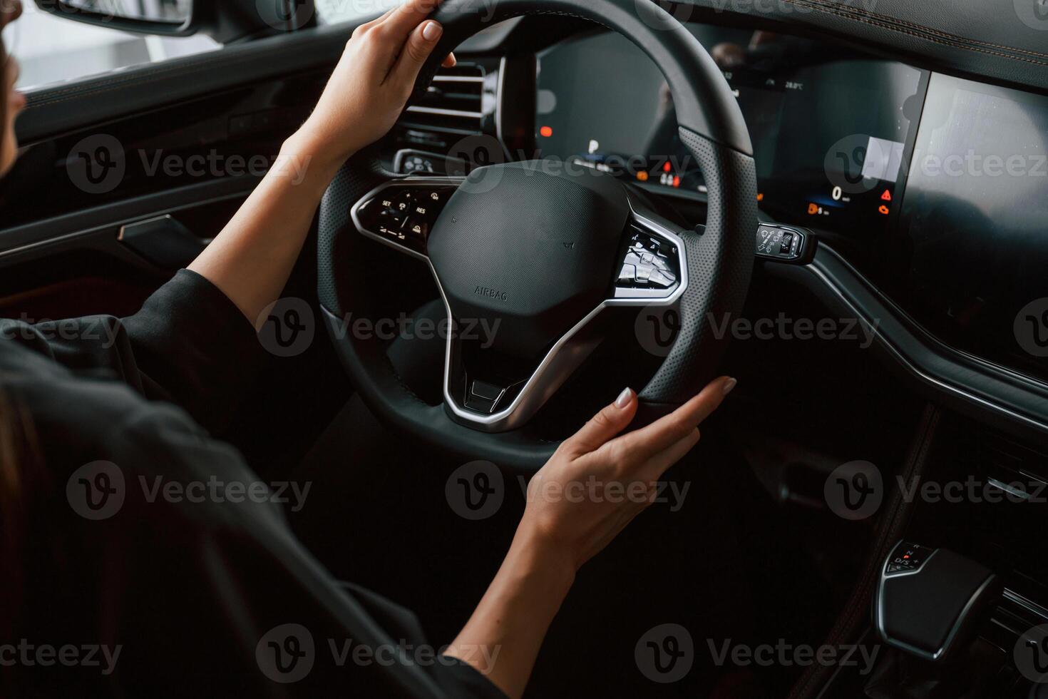 Focused close ,up view of woman hands that are driving new car photo