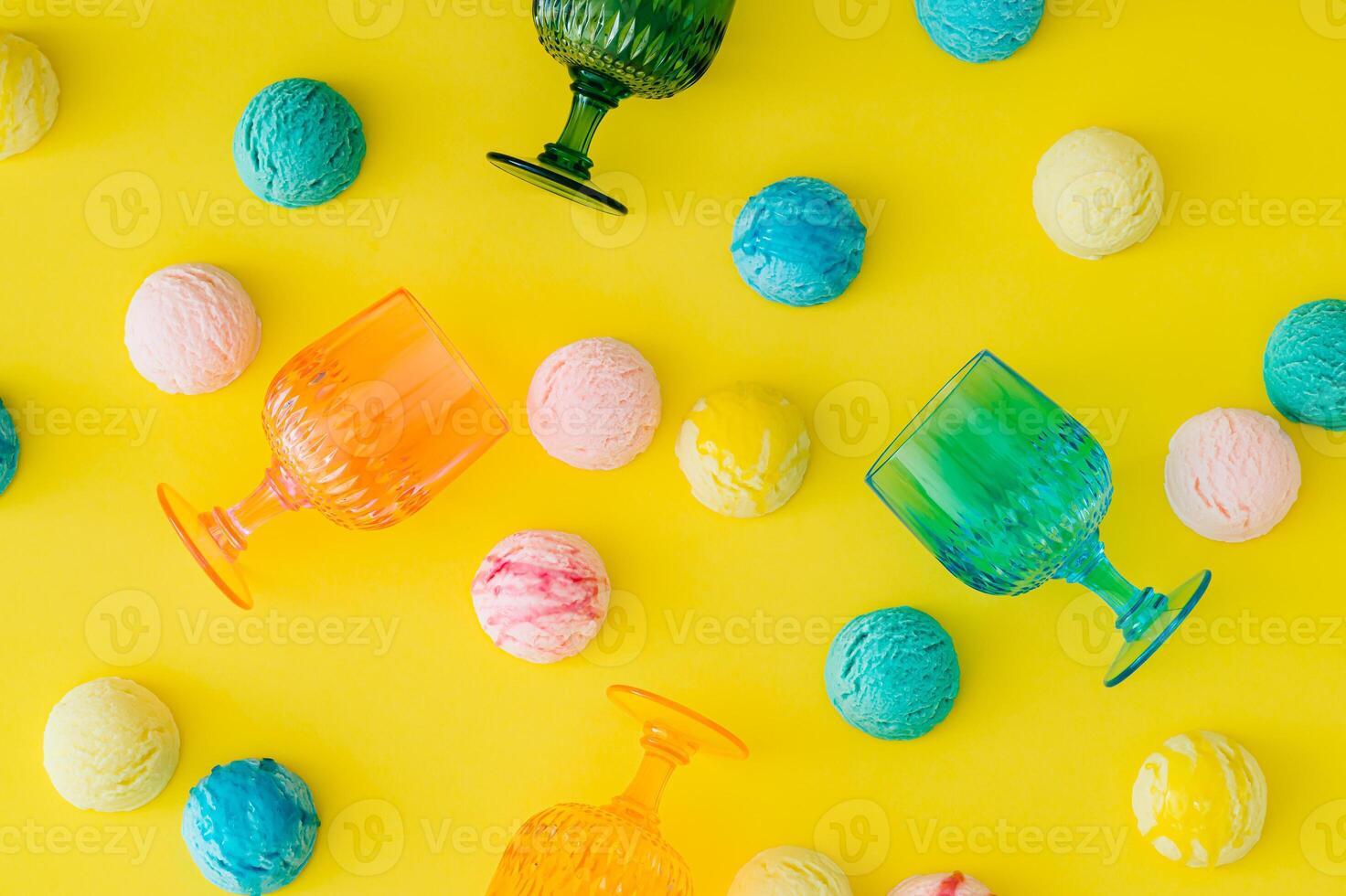 Colorful pattern with ice cream scoops and vibrant cocktail glasses on bright yellow background. Food and drink concept. Trendy party idea. Fun, festive and playful layout. Flat lay style. Top view. photo