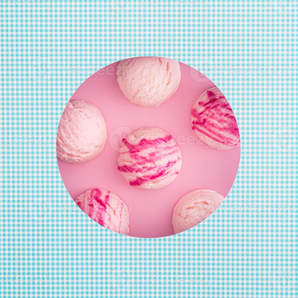 Summer composition with strawberry ice cream scoops visible through a circle shaped gap. Creative sweet food concept. Trendy yummy dessert idea. Flat lay style background. Top view banner. photo